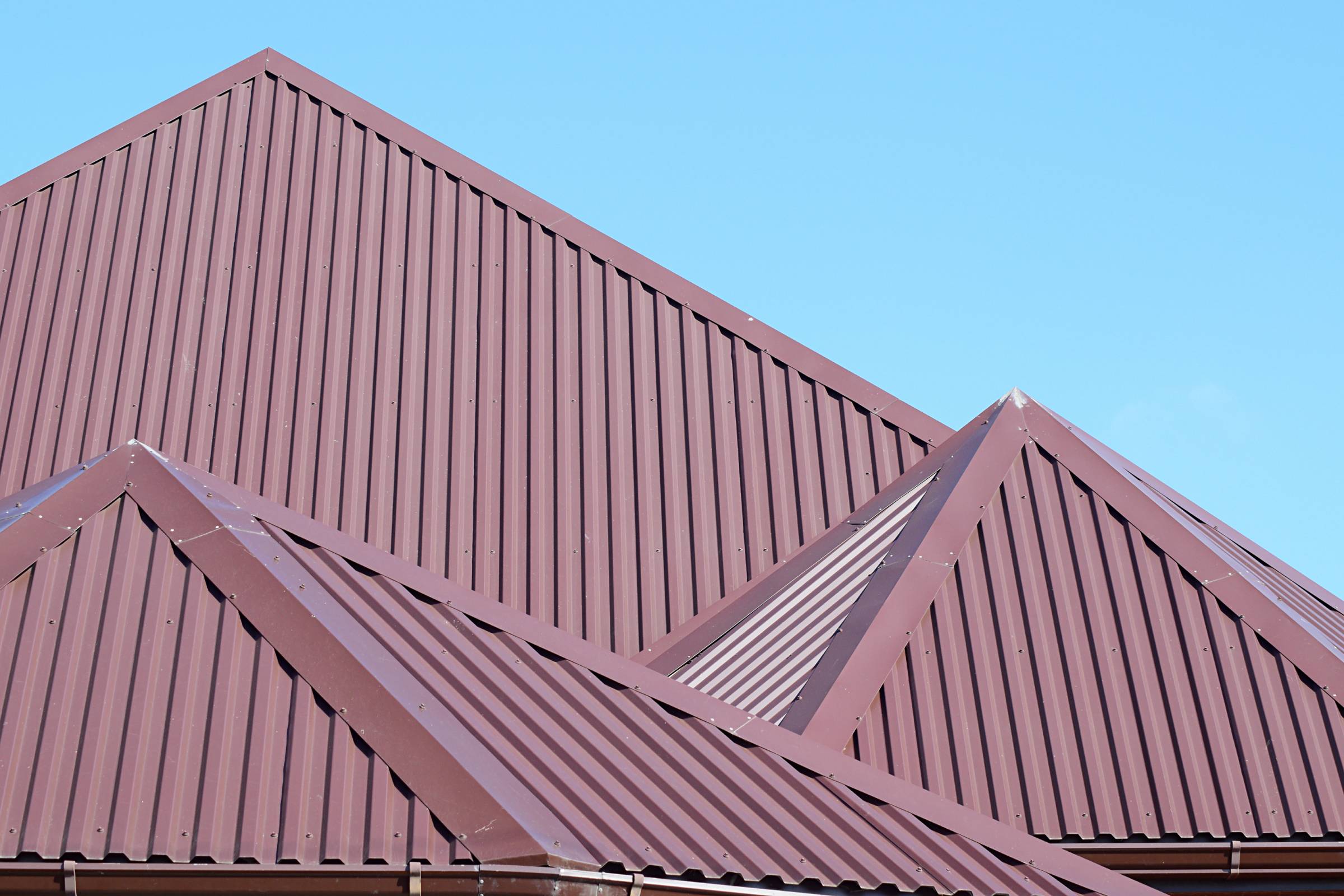 a house with a maroon metal roof