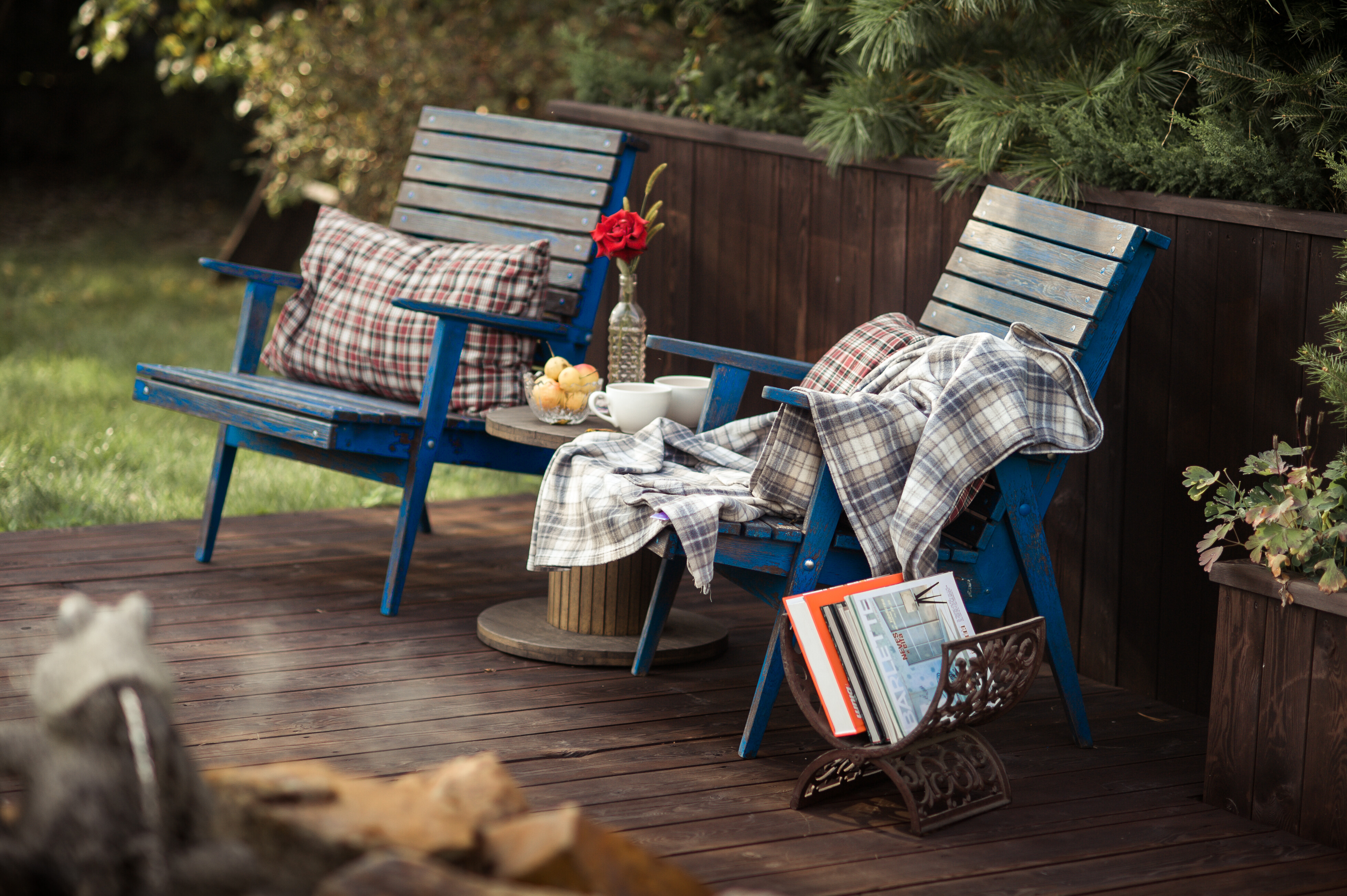 wooden chairs with blankets and pillows