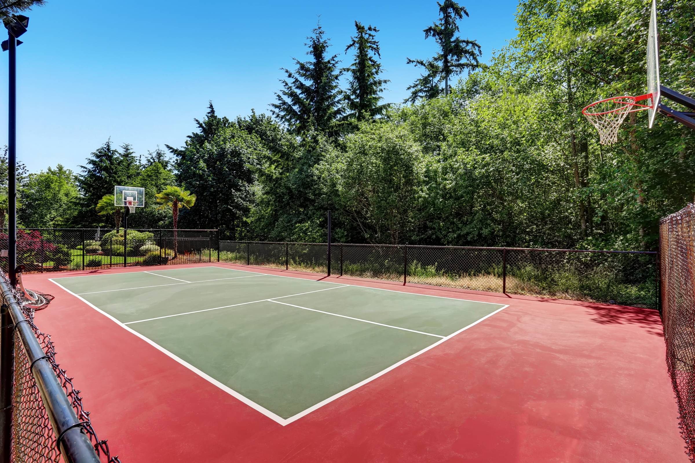 a freshly painted backyard basketball court
