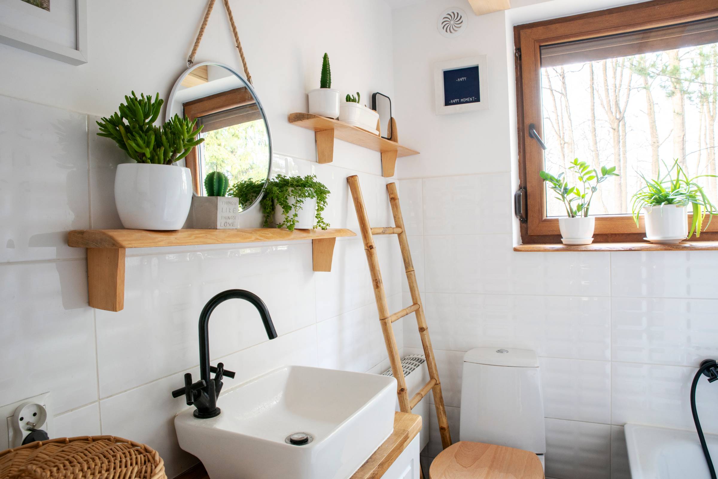 a small bathroom with a corner sink and toilet