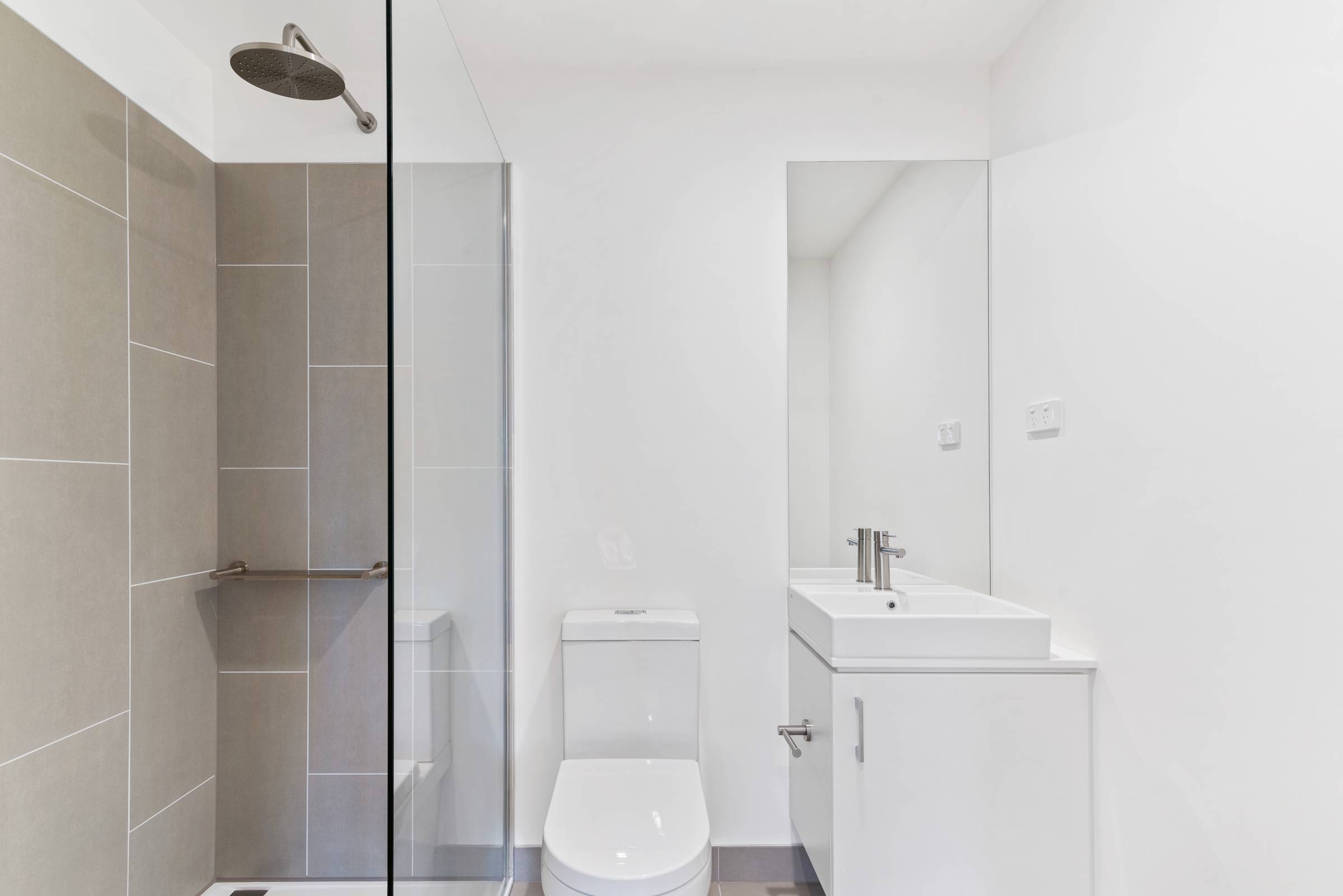 a small bathroom with a sliding shower door