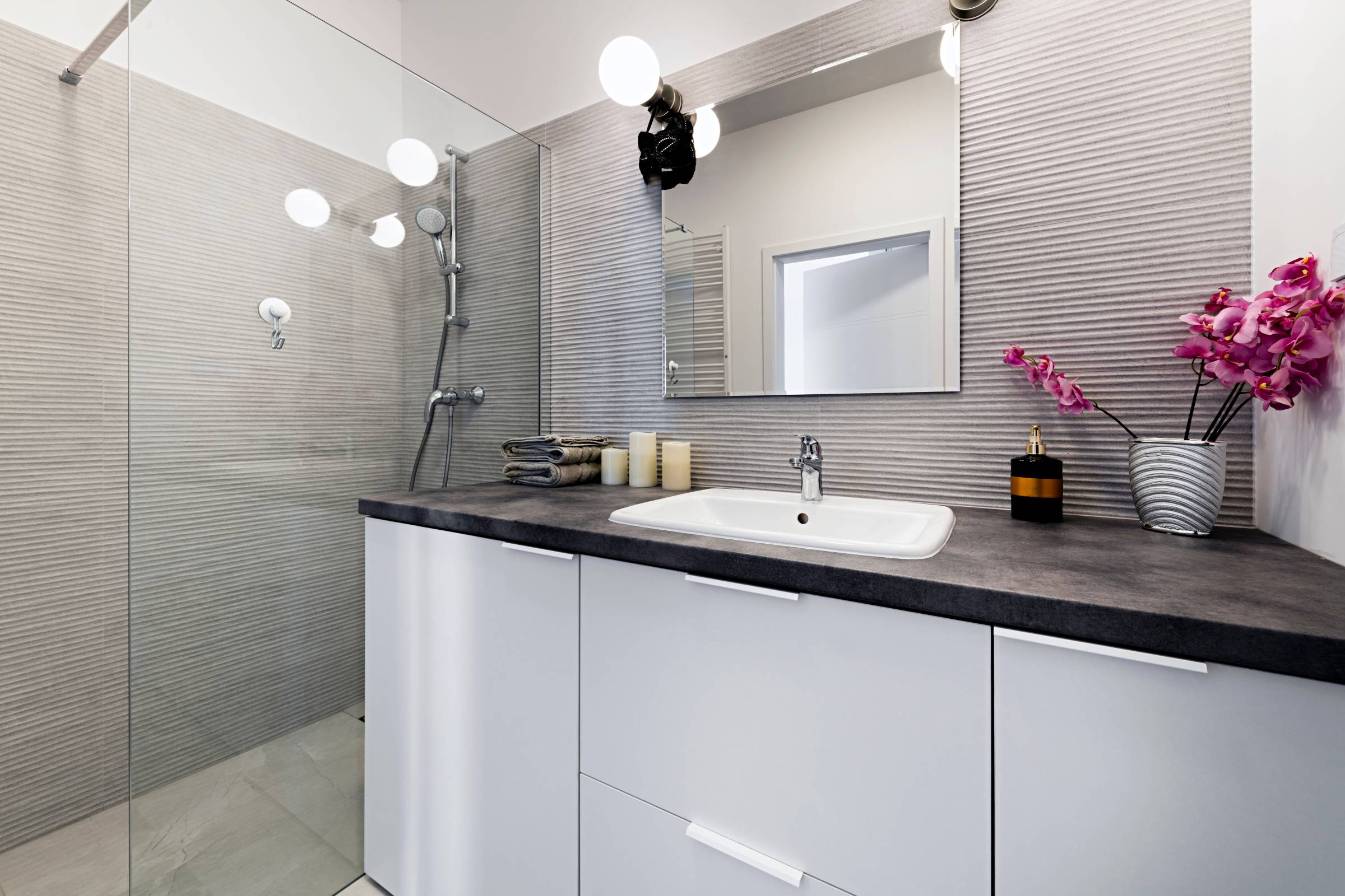 a small bathroom with artificial lighting