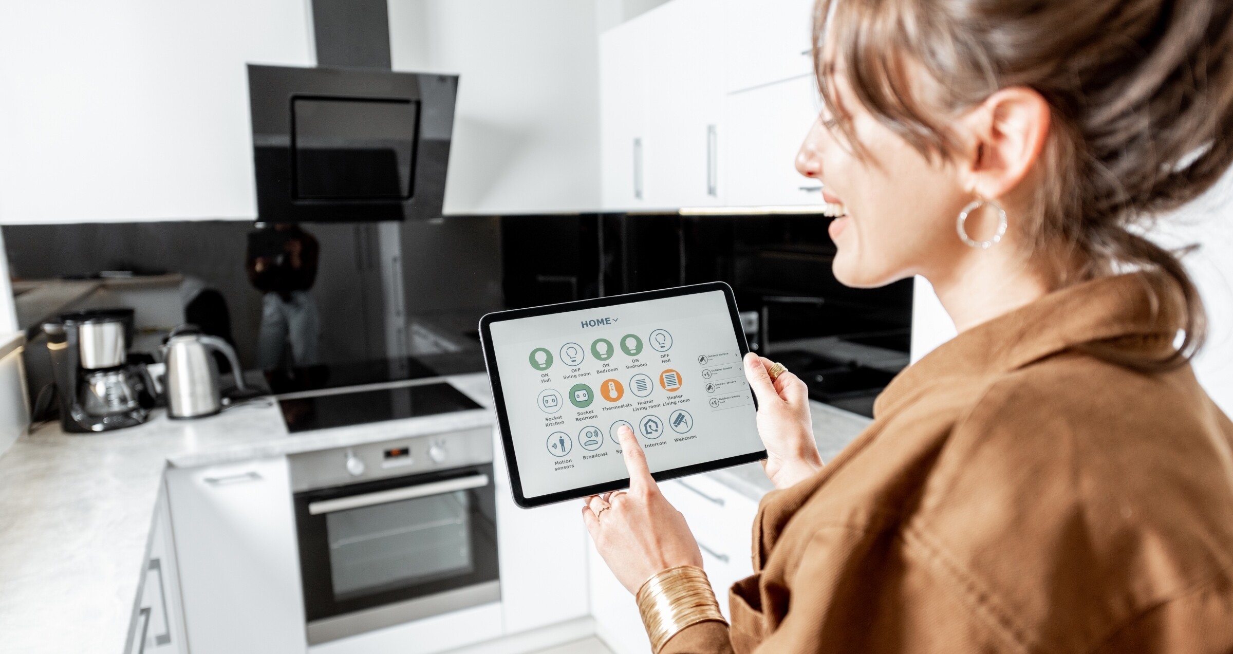 person controlling smart tablet at kitchen