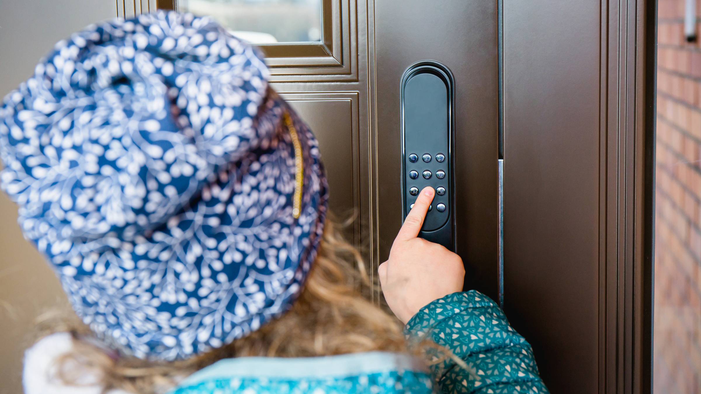 a child unlocking a smart door lock