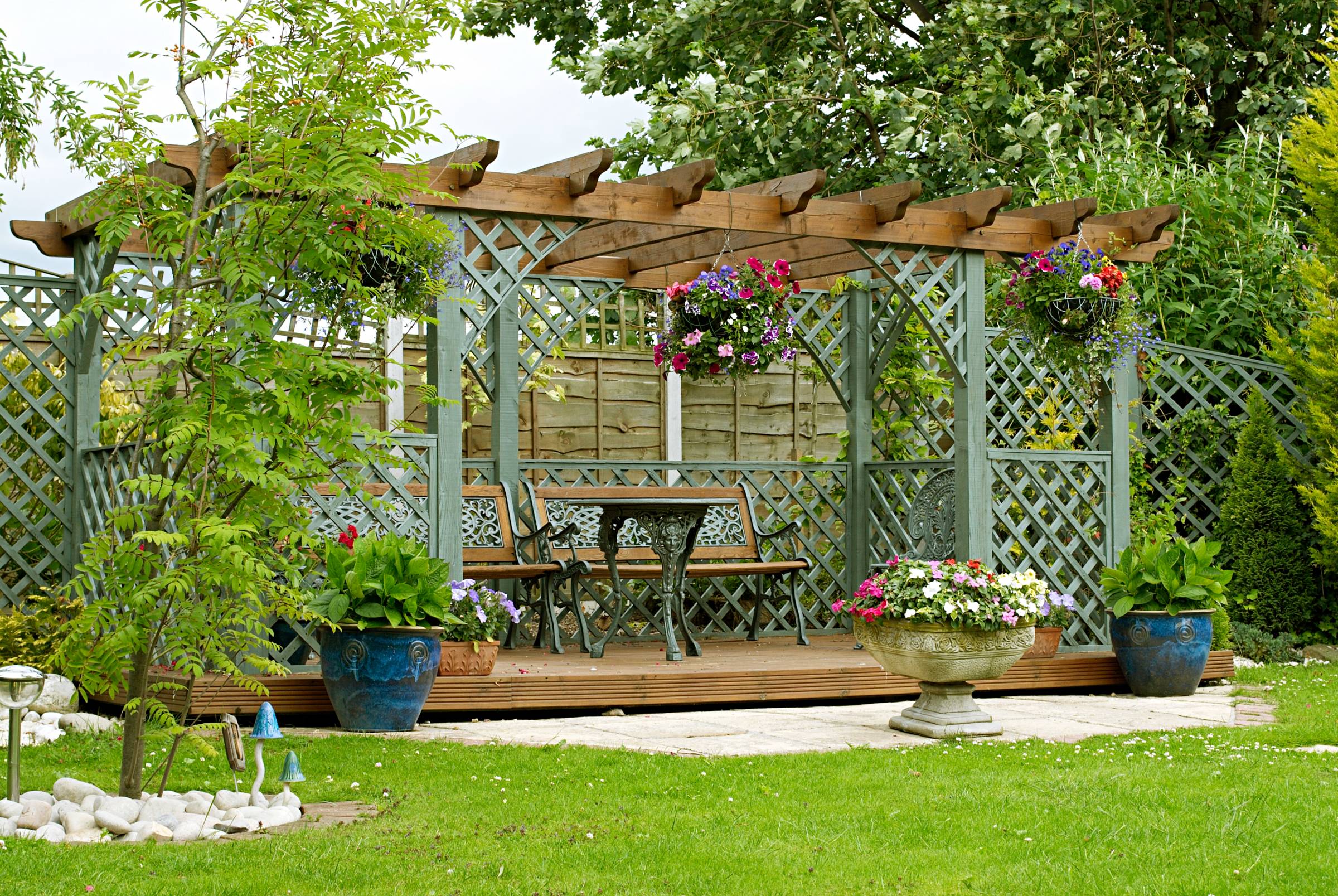 a pergola with benches and flowers