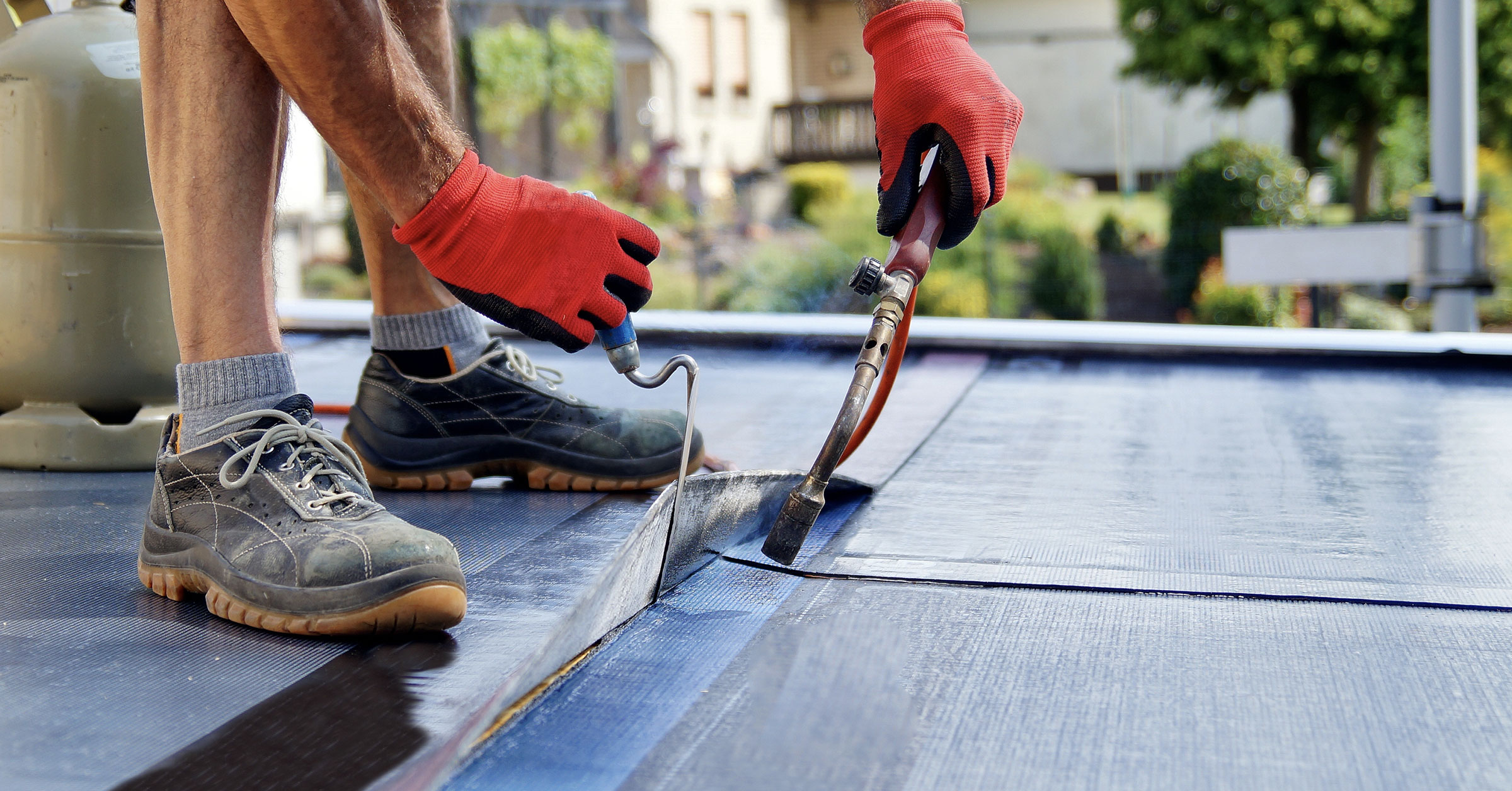 A close up shot of a professional waterproofer doing his work with the proper tools.