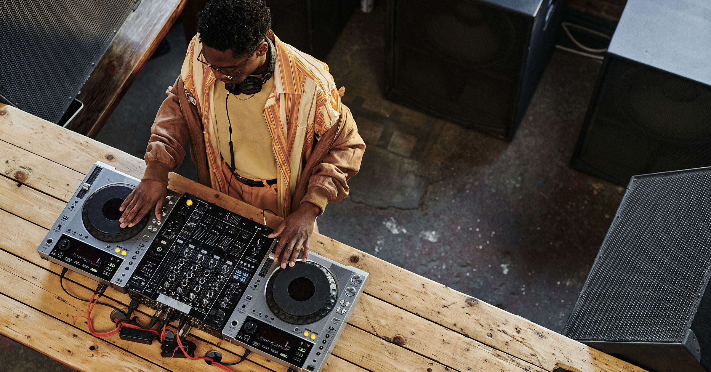 A bird's eye view of a DJ during a set at a party or event.