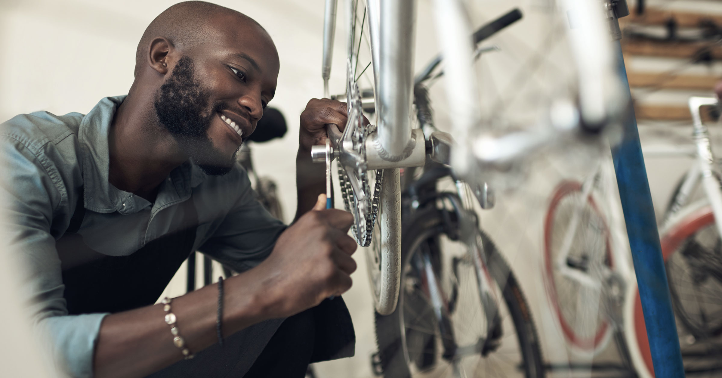A close up picture of a bike mechanic tightening the bolts of the cranks