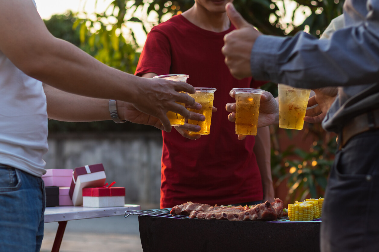 friends at a cookout with beer in hand