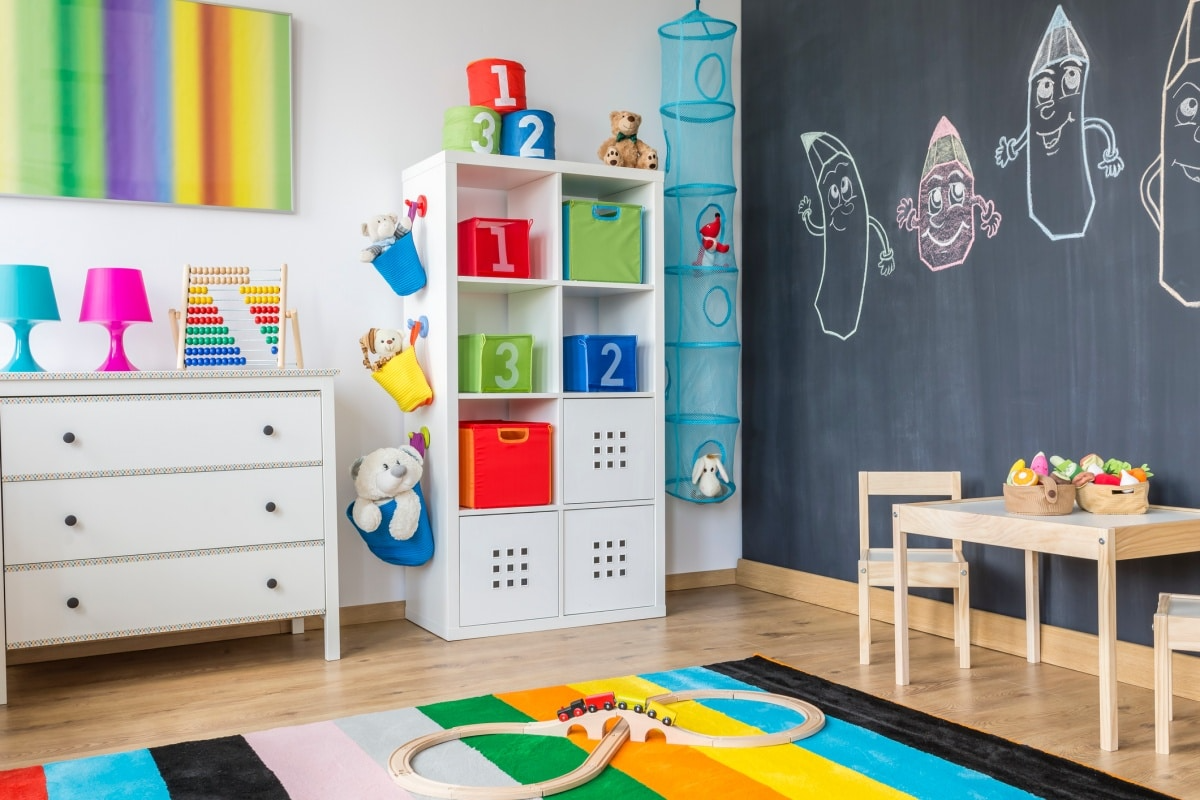 Colourful playroom with a cabinet, chest of drawers and table for a child