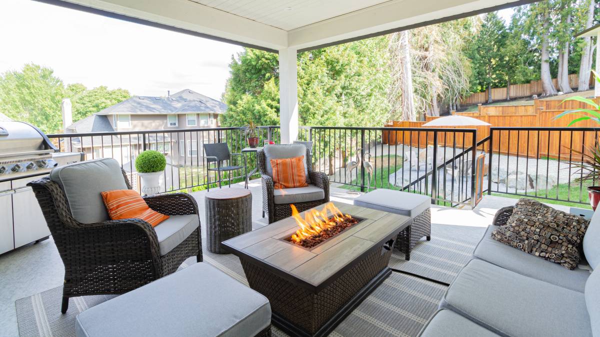 a spacious deck with a fire pit