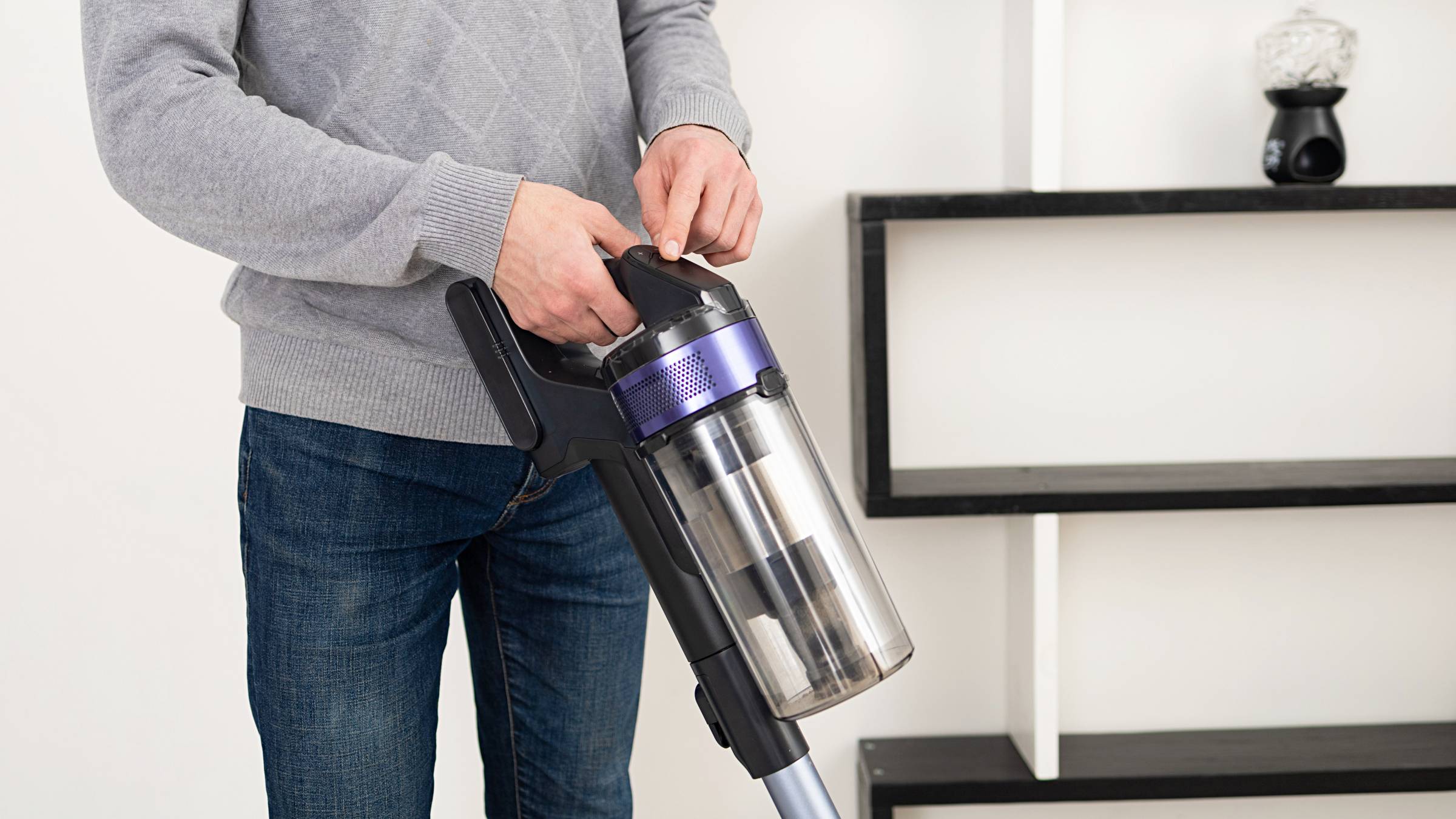 a man using a cordless vacuum cleaner