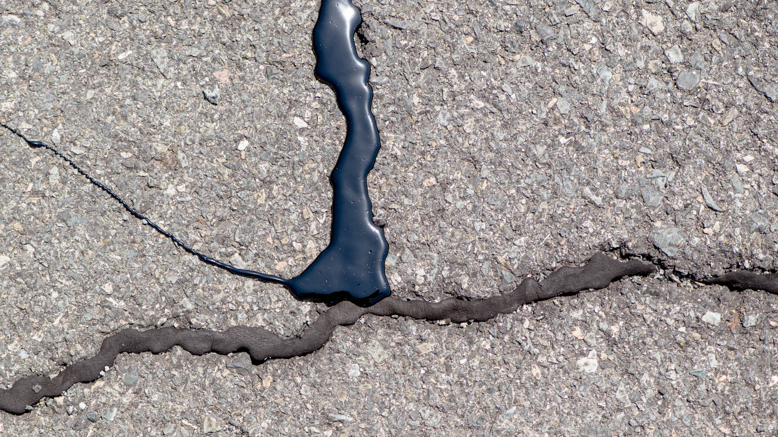 laying bitumen on an old asphalt road