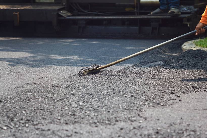 a road worker laying asphalt