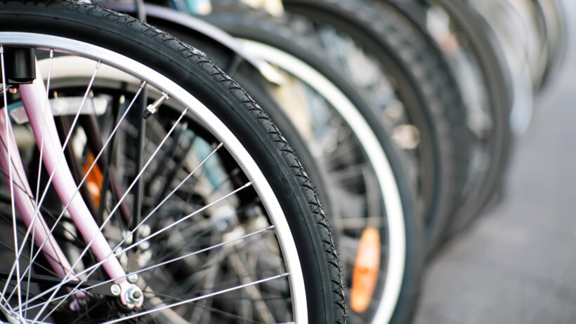 a close up of bicycle wheels to compare the difference between gravel bike vs road bike in terms of tyre width