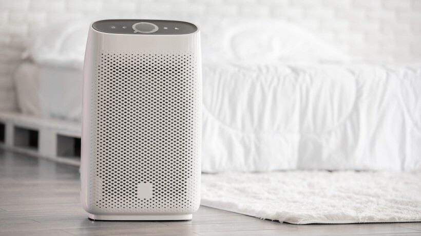 Air purifier vs dehumidifier - Air purifier in cozy white bed room for filter and cleaning removing dust