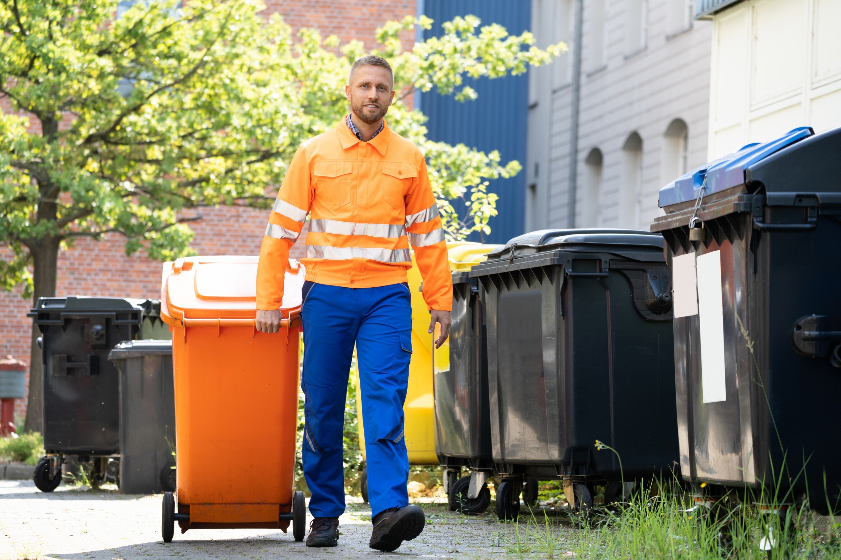 Garbage removal man doing household waste and rubbish collection.