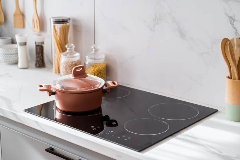 induction stove with a pot on it - gas vs induction cooktop