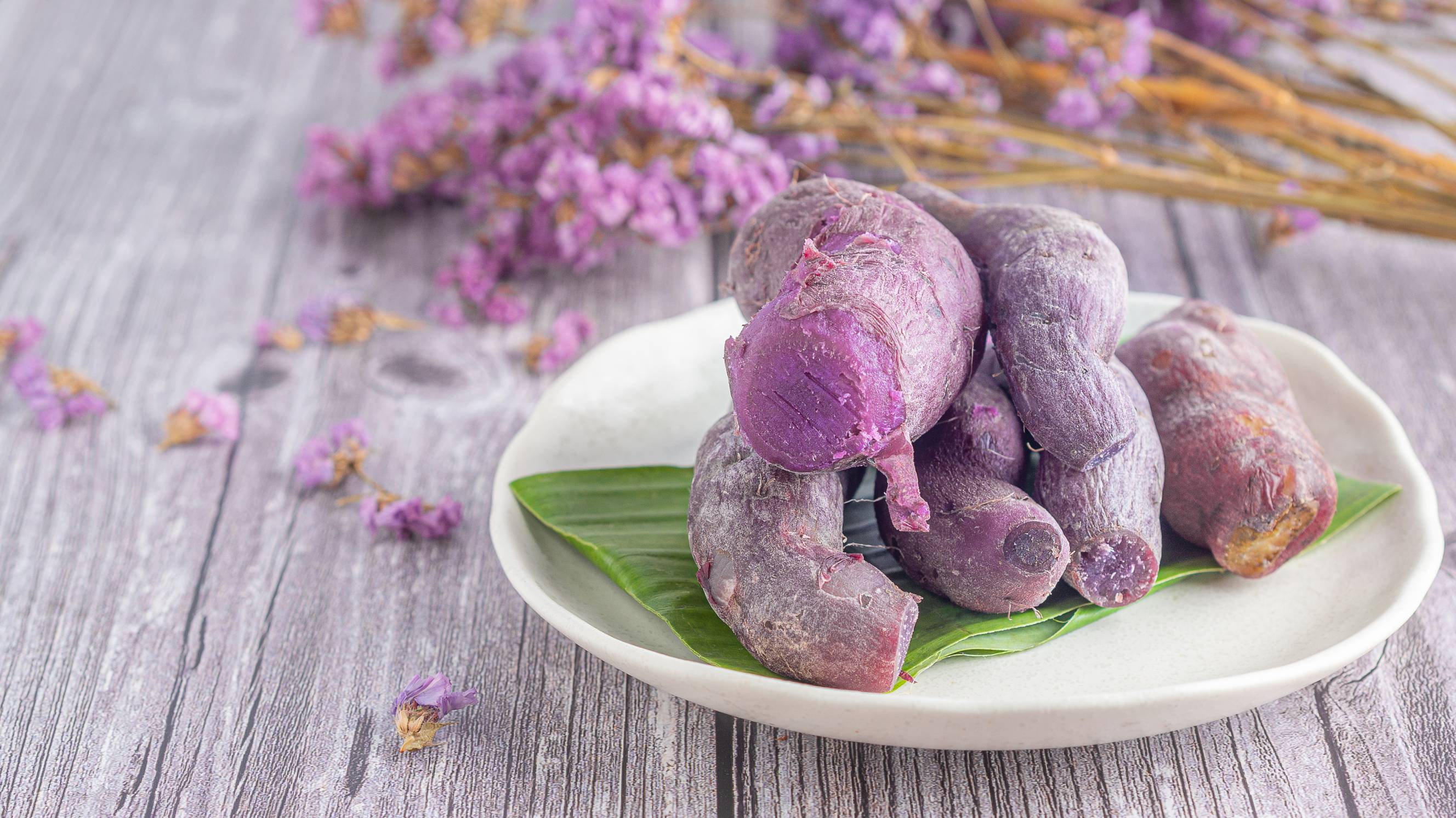 Ripe purple yam on a plate on a wooden table