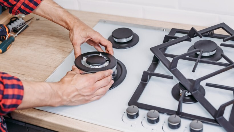 Gas vs electric range - A person installing a new gas range