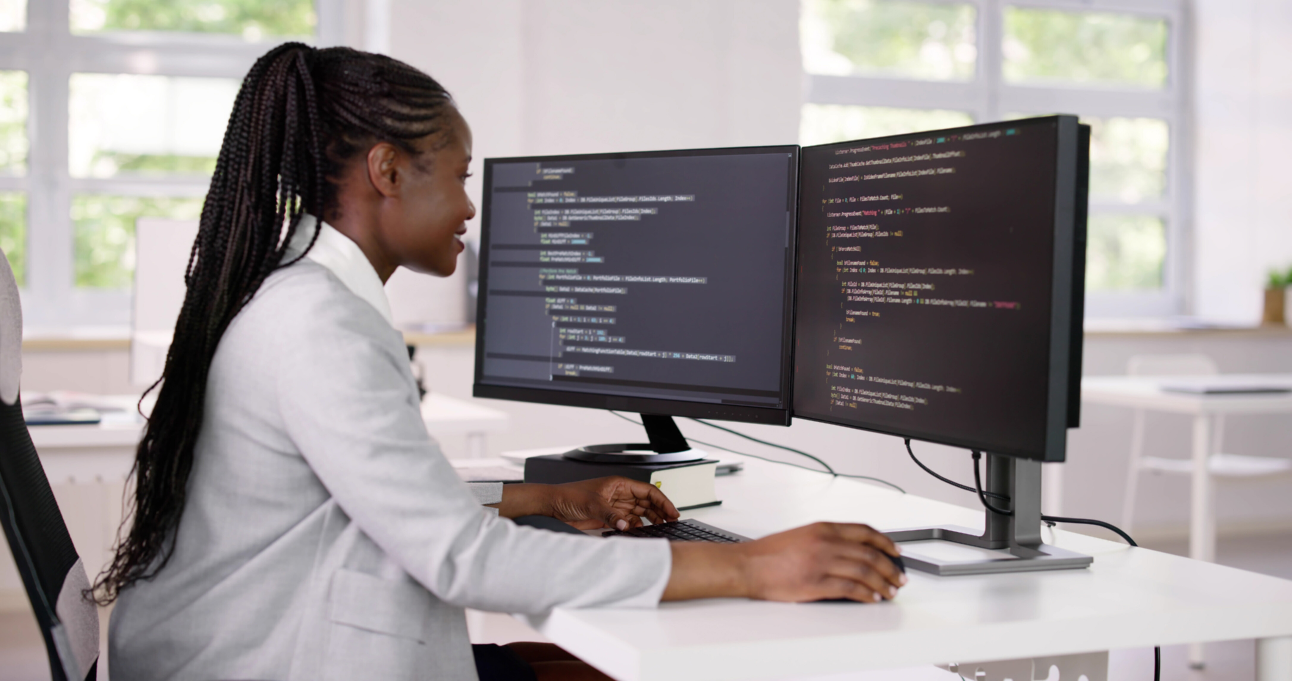 A female programmer working on her desk.