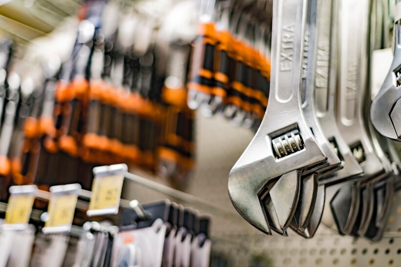 Spanner vs wrench - Wrenches and other different tools on display in a hardware store.