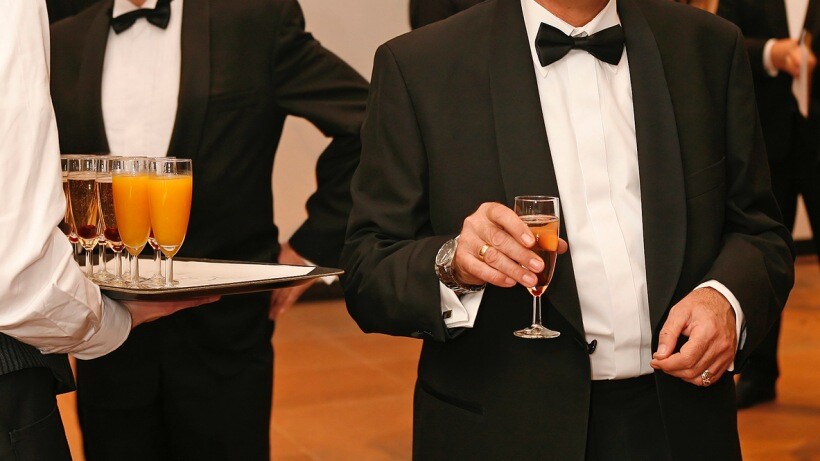 Tuxedo vs suit - A close-up of a person wearing a tuxedo at a reception gala party