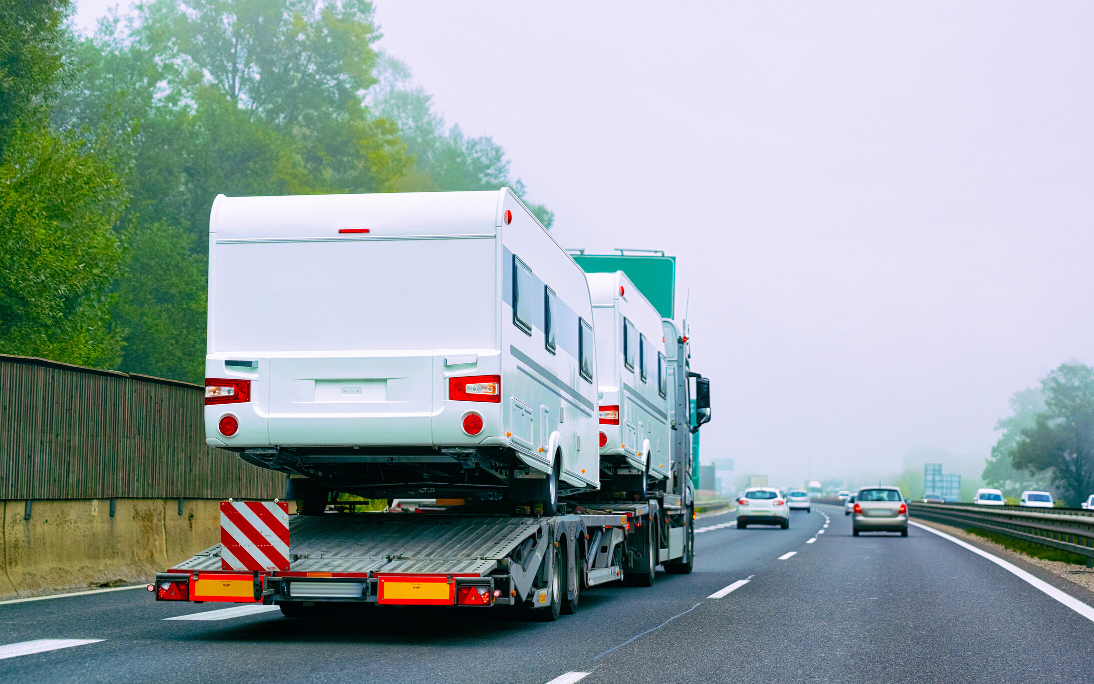 RVs are being transported by truck.