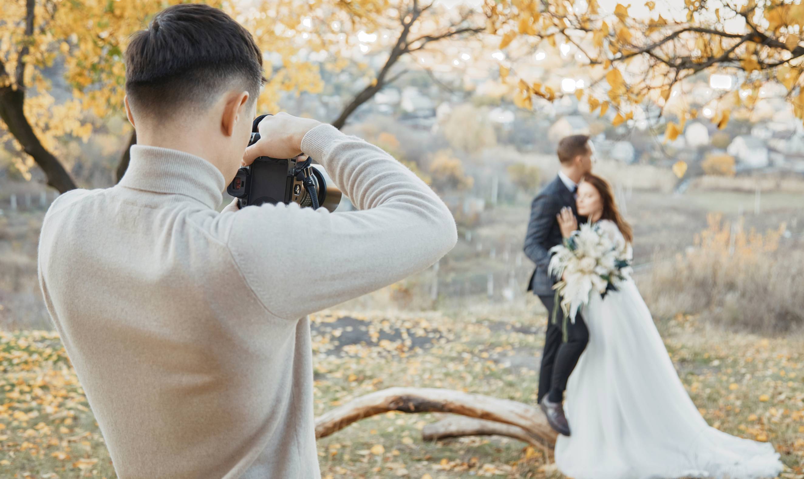 A photographer taking a photo of a couple for their destination wedding shoot.