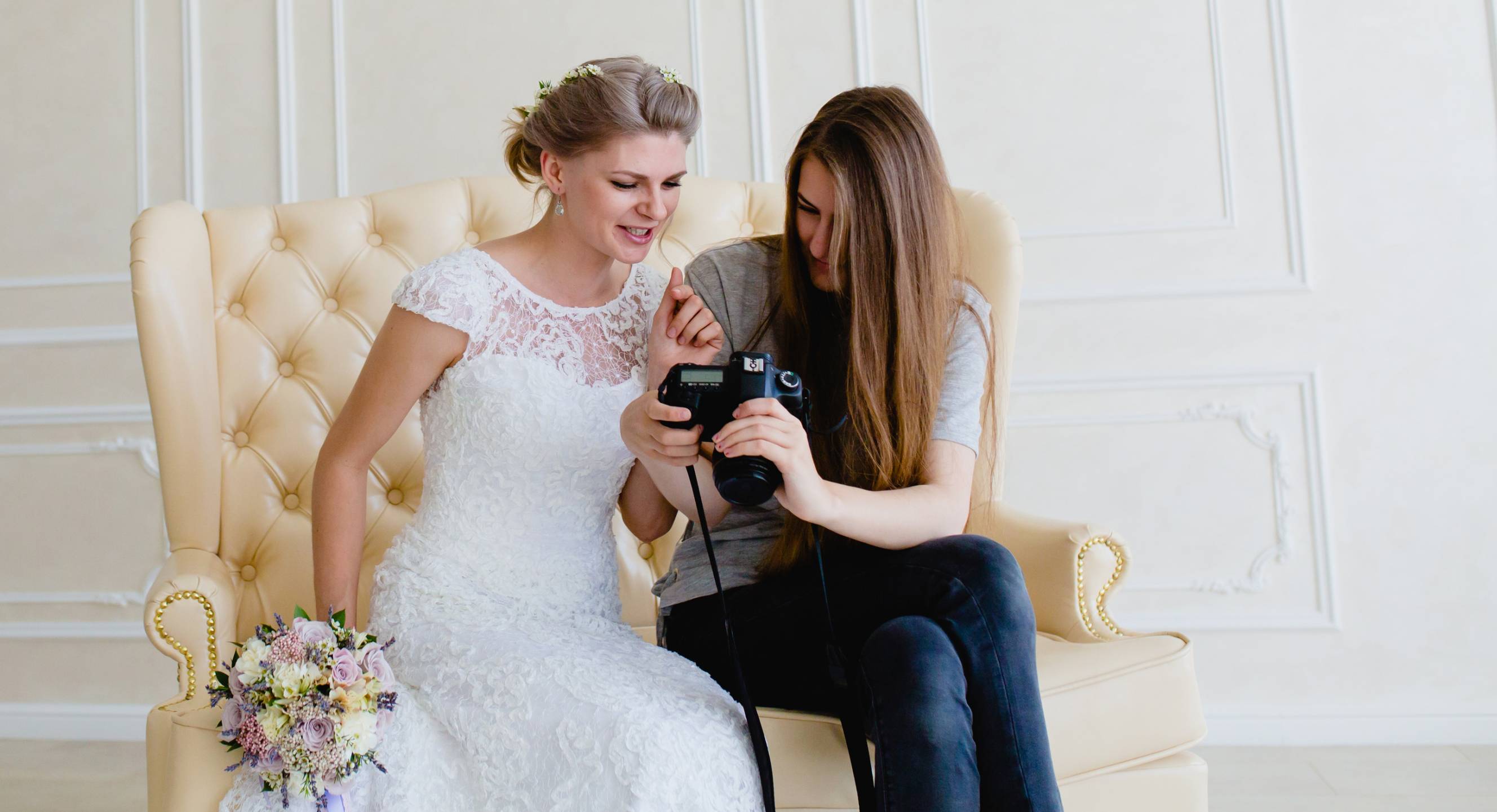 A documentary wedding photographer shows the bride pictures she took with her camera.