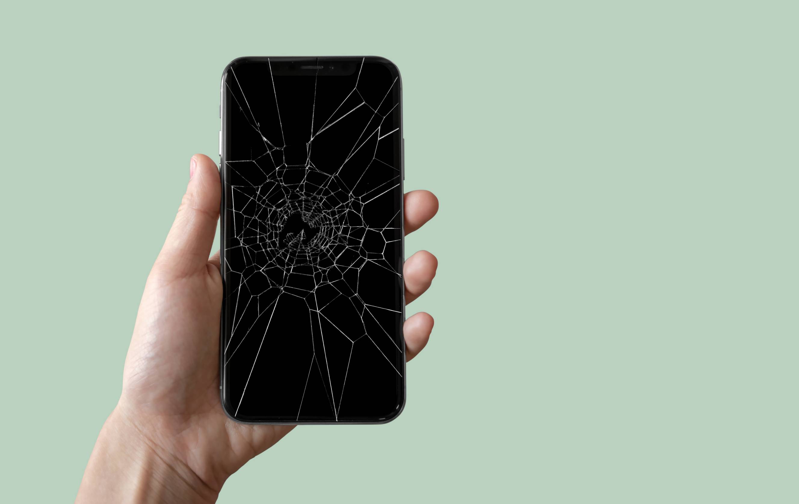 An iPhone needing Apple help services due to a cracked screen.