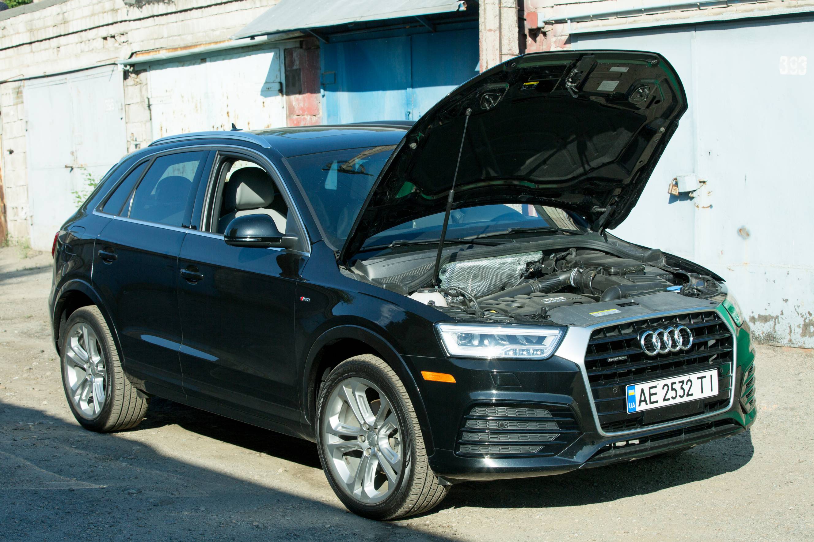 A black Audi Q3 ready for Audi servicing by an experienced mechanic.