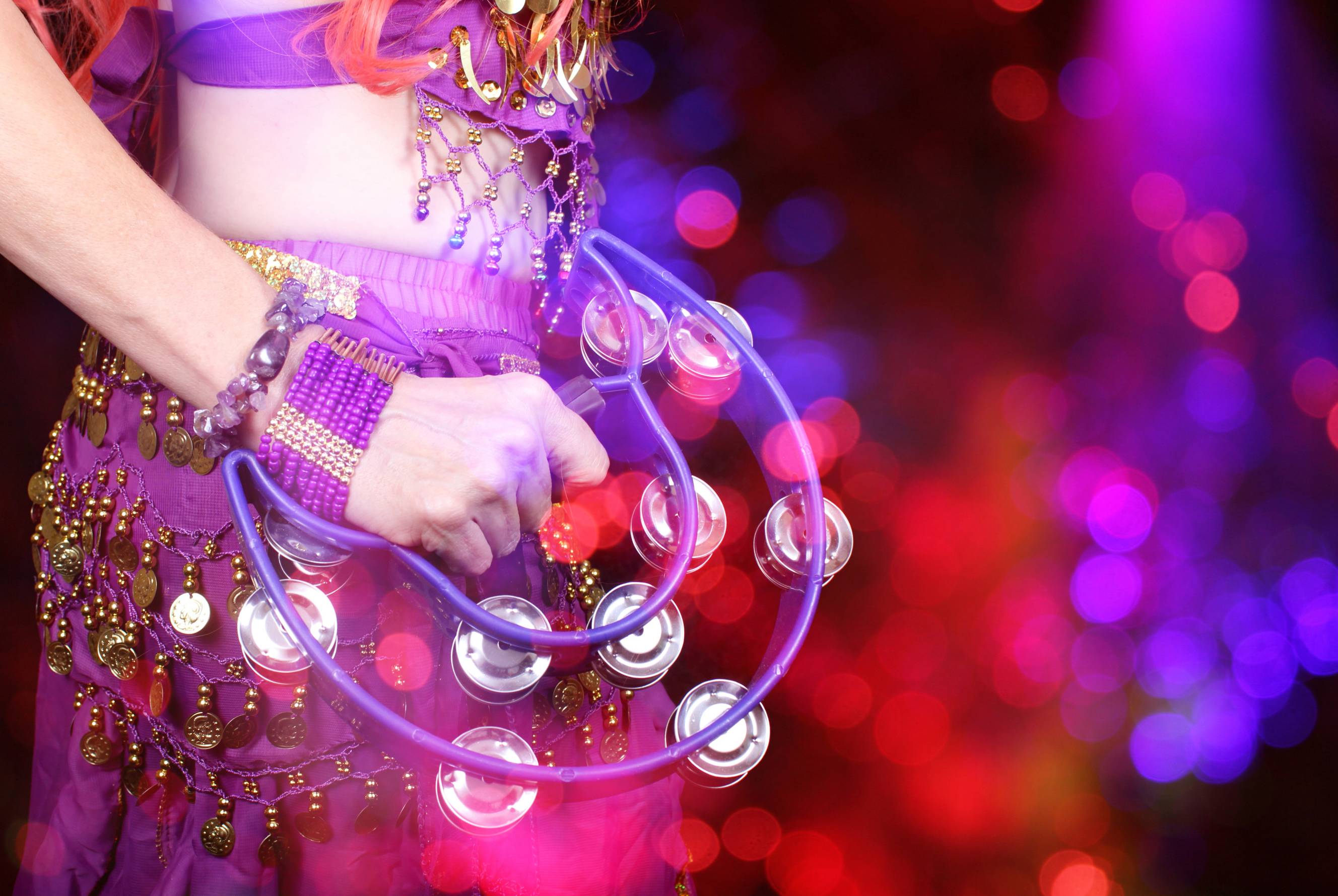 Belly dancer holding a tambourine for party entertainment