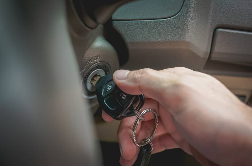 car key replacement - a man starting a car with a new key