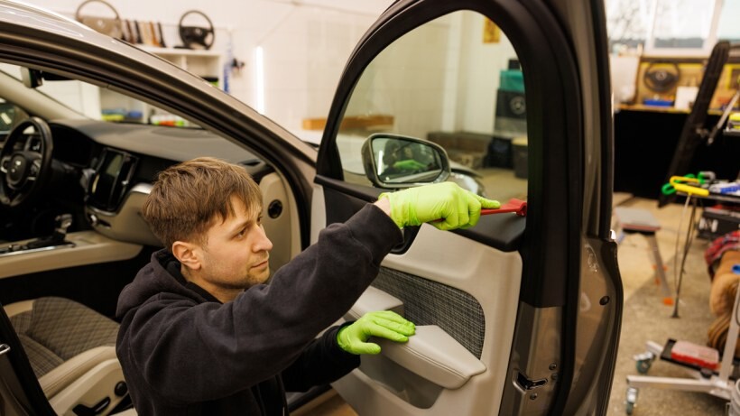 Car detailing vs car wash - A person cleaning the interior of a car