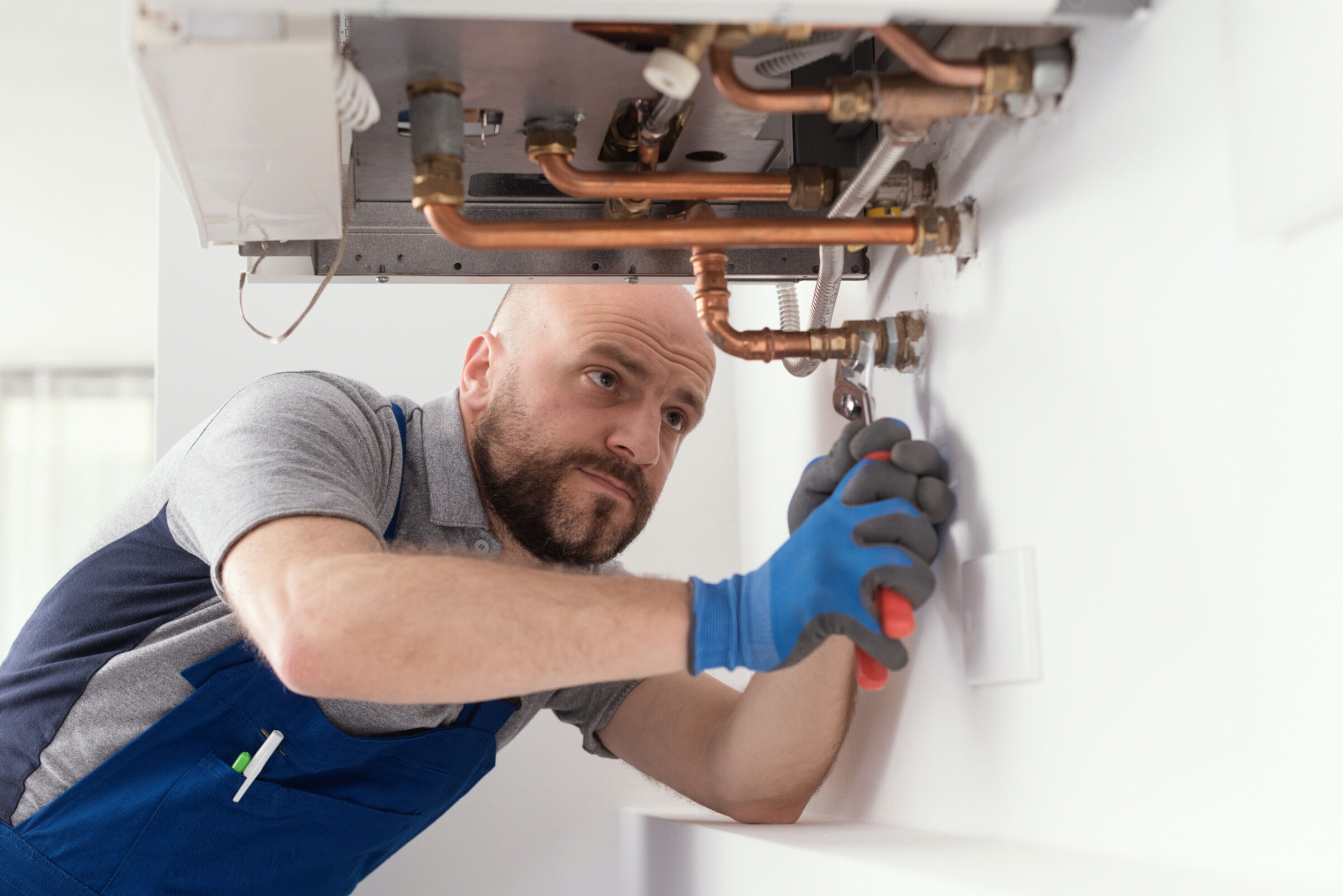 Professional engineer installing a gas boiler.