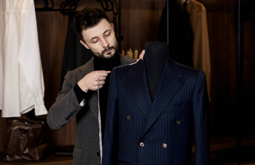 double breasted vs single breasted - Tailor measuring a double-breasted navy pinstripe suit