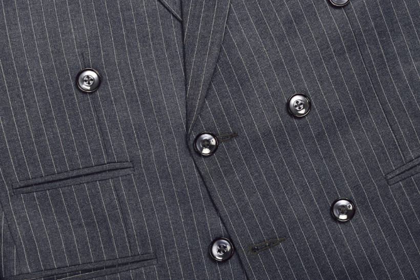 double breasted vs single breasted - Close-up of a double-breasted suit jacket with pinstripe pattern and button configuration