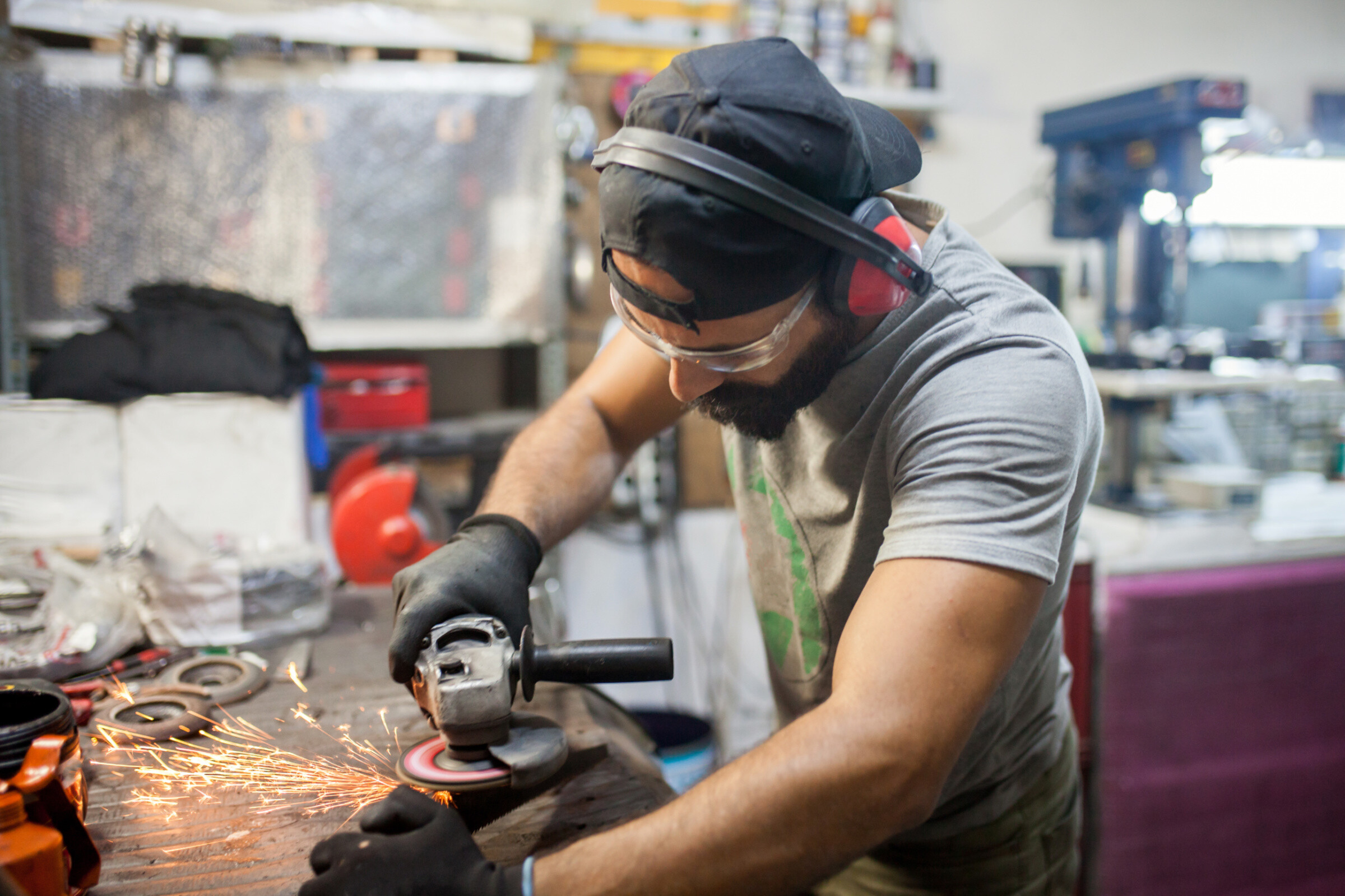 Worker grinding metal.