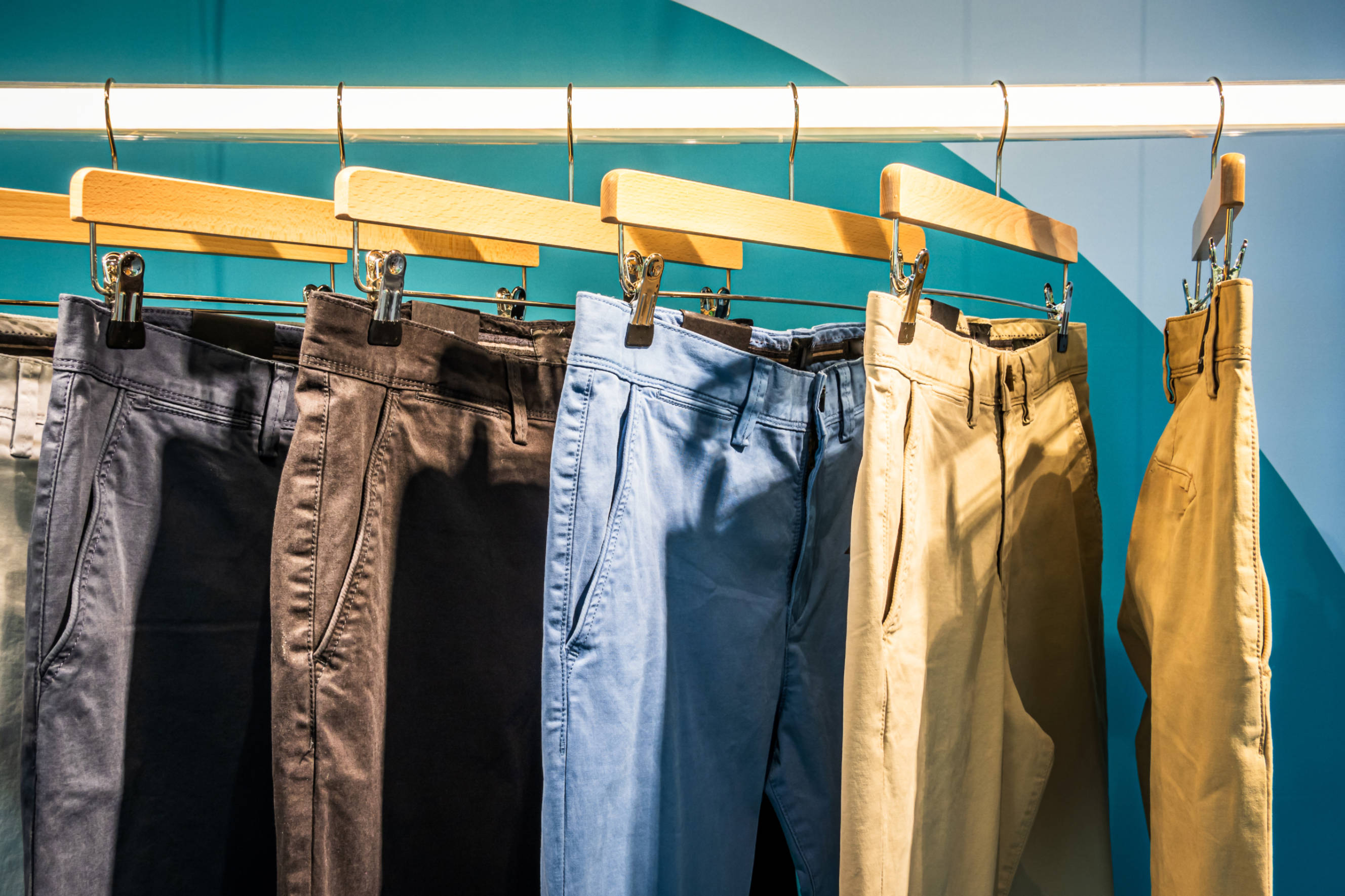 A display of chinos and khakis in various colors, highlighting options for casual and smart-casual wear.