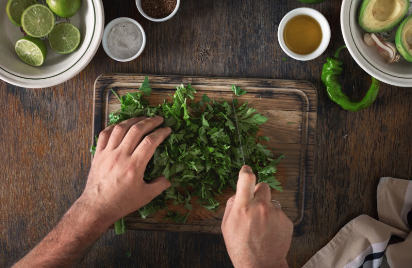 parsley vs coriander - Coriander being prepared in a kitchen setting