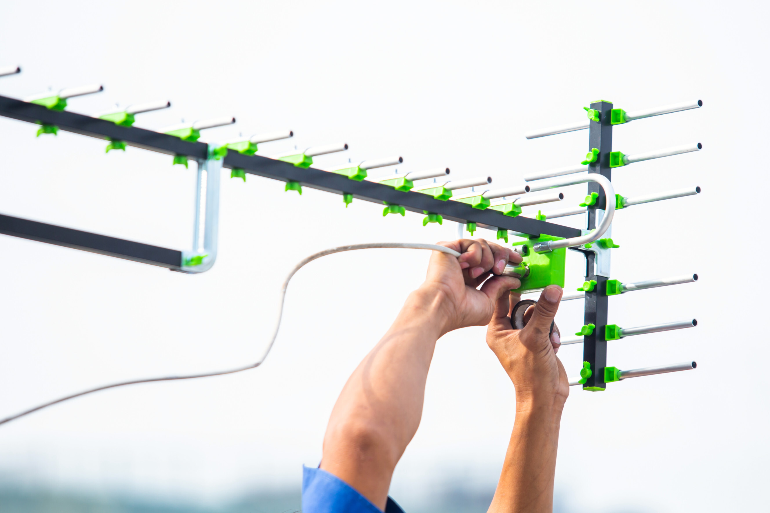 Technician installing a digital antenna with precision, showcasing professional digital antenna installers near you.