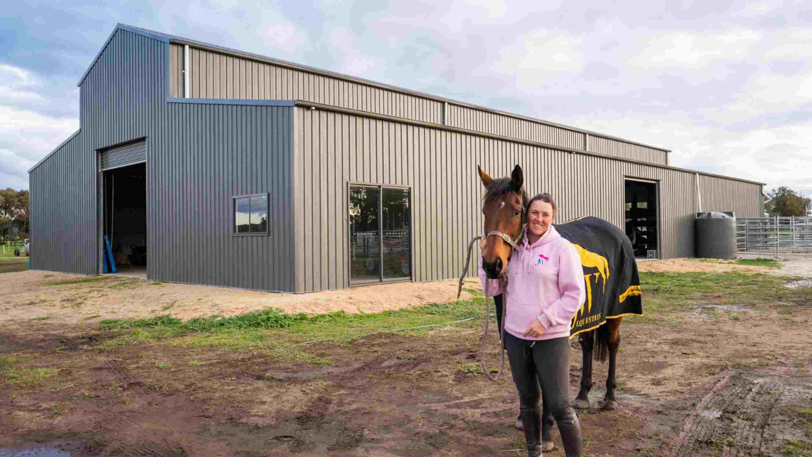 Barn vs shed - A durable steel barn by Easyshed, designed for equestrian needs, featuring large open doors and windows