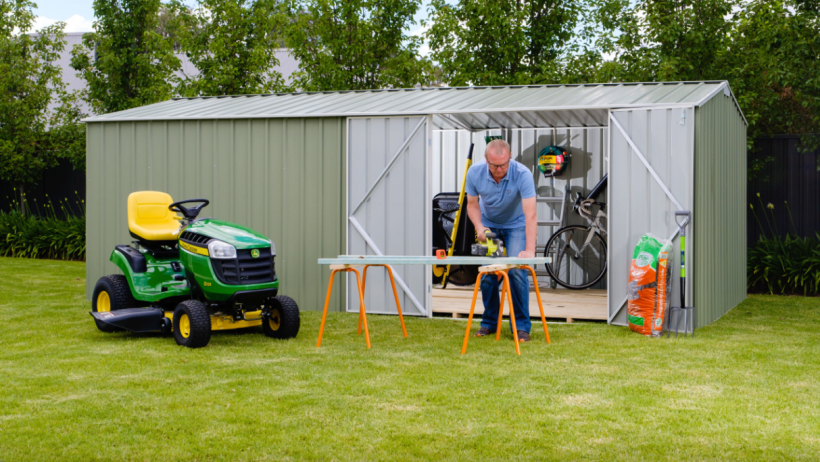 Metal shed vs wood shed - A metal shed by Easyshed, with double doors open to reveal organised storage for tools, bicycles, and equipment