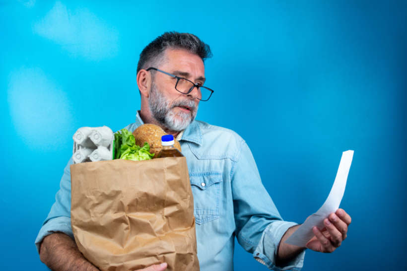 Iceberg lettuce vs romaine - A man holding a grocery bag and receipt