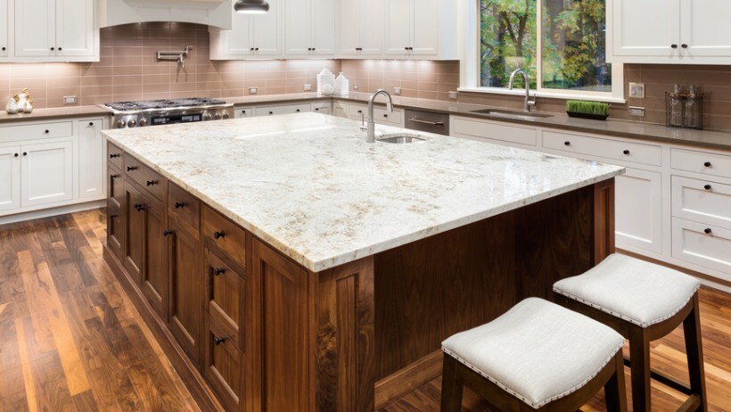 Quartz vs granite benchtops - A spacious kitchen featuring a durable benchtop with a polished finish