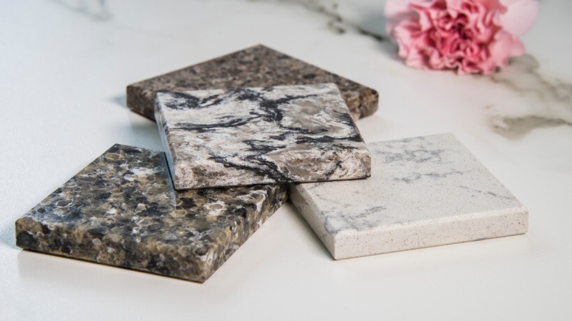 Quartz vs granite benchtops - Close-up of four benchtop samples showcasing different patterns and textures