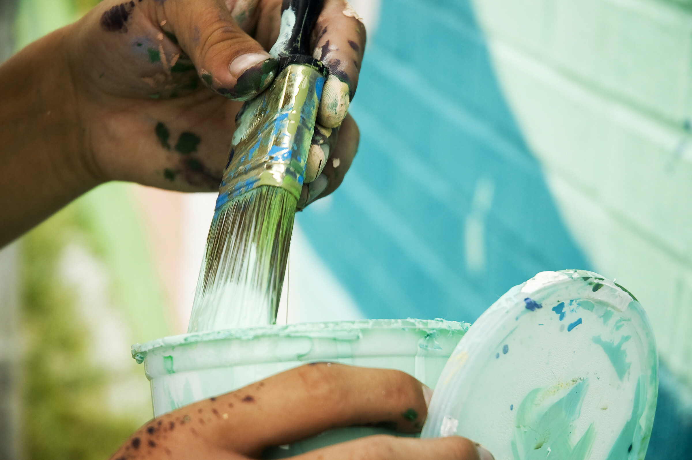 Close-up of muralist painting