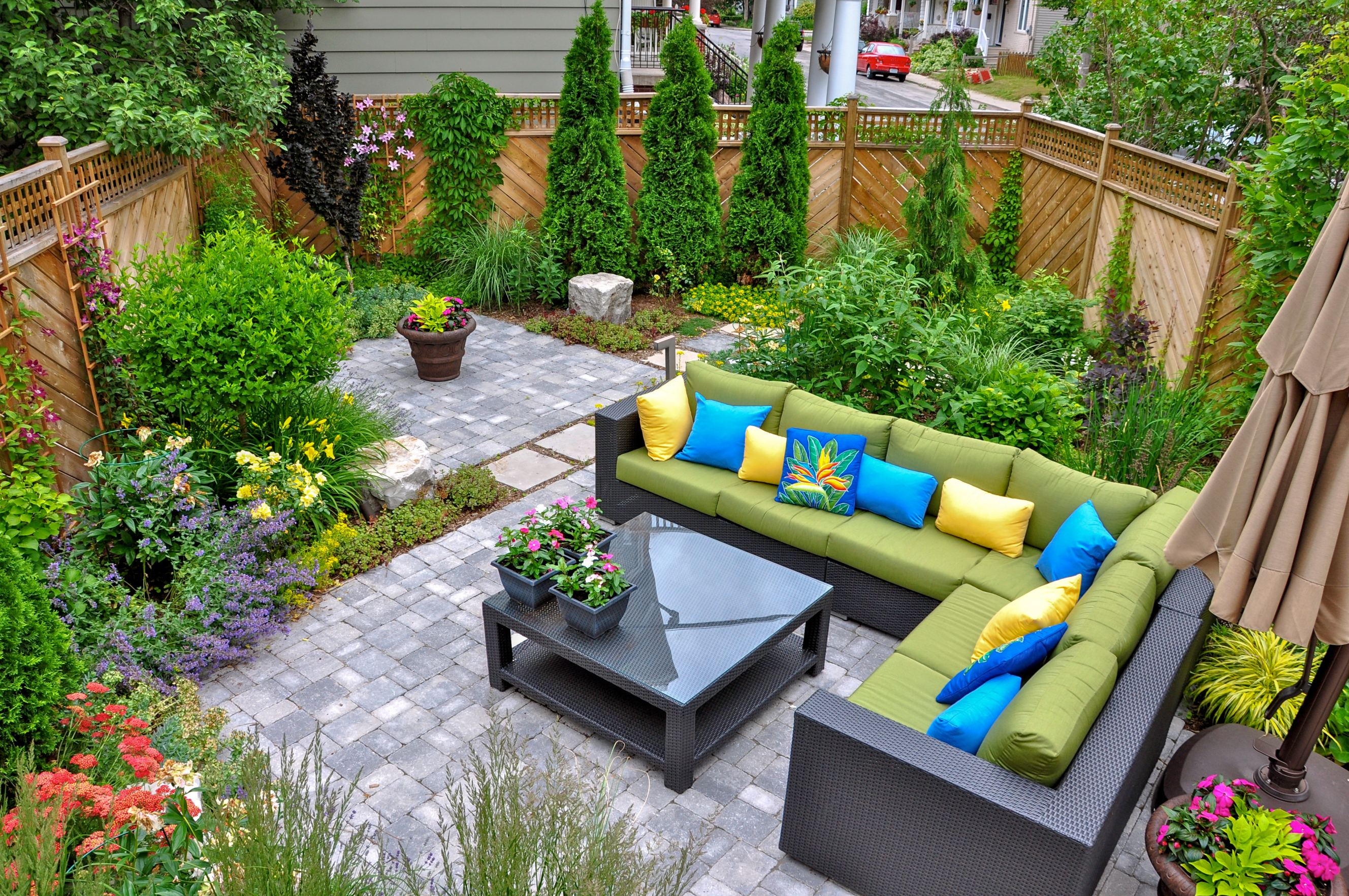 A beautiful, small, urban backyard garden with fabulous hardscaping and a variety of trees, shrubs, and perennials.