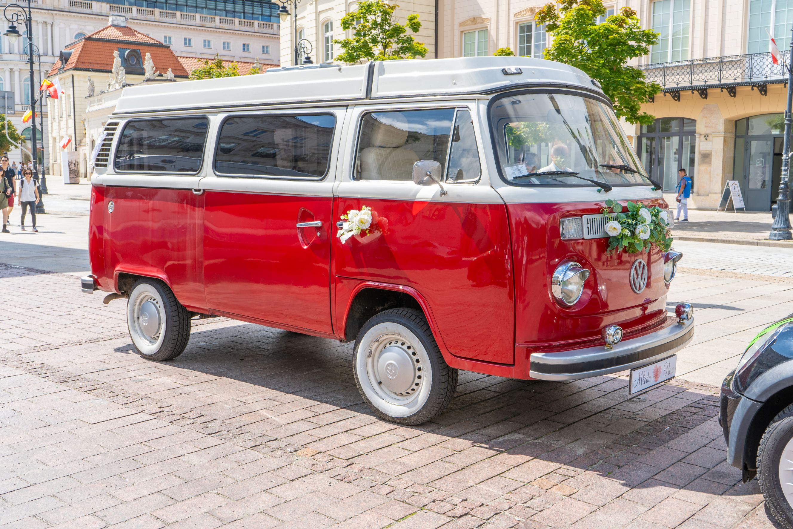 Red minibus Volkswagen for wedding bus hire near me.